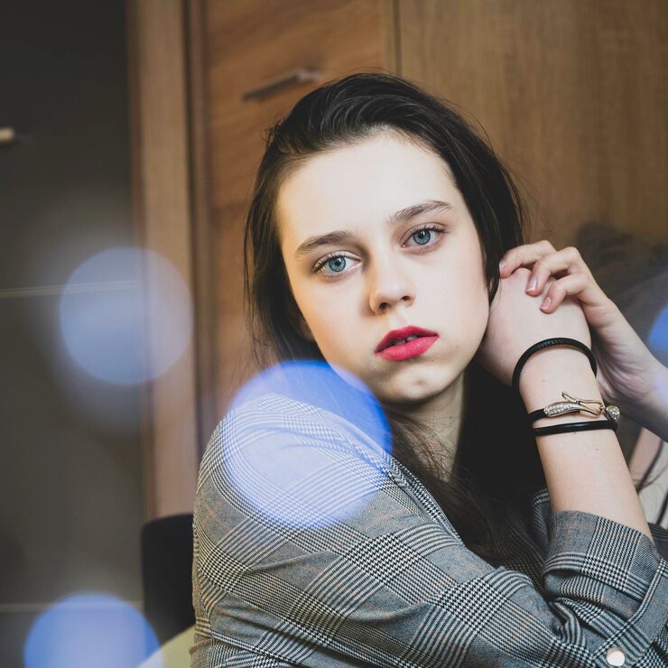 portrait-serious-teenage-girl-sitting-home_1048944-21512880
